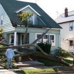 damaged house from tree collapse due to storm