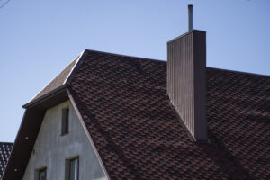 Brown corrugated roof on a suburban home with chimney