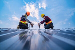 Two workers installing a new roof