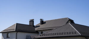 Brown roof on a suburban home with chimneys