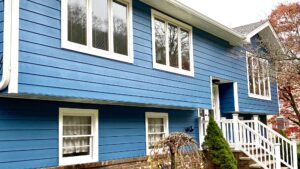 Split-level home with bright blue siding and white trim