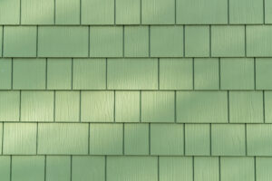 Close-up of light green cedar shake siding on a home