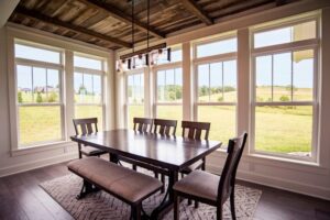 Bright and open dining room with large windows lining each wall