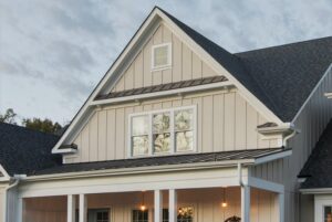 Home with A-line roof and beige board-and-batten siding